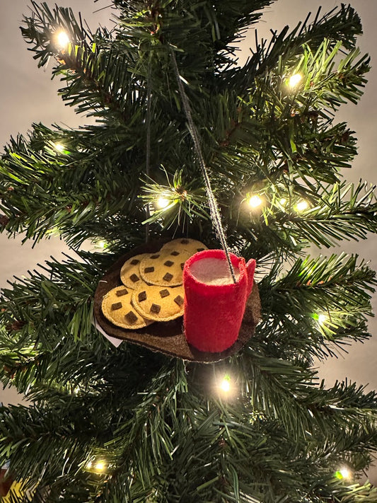 Christmas tree ornament with a red boot and cookies hanging from a string.