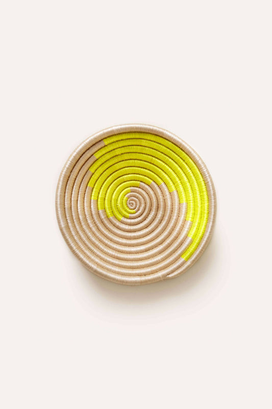 Round woven coaster with concentric circle pattern on a white background