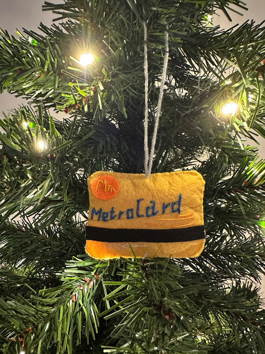 Small plush Metroland bag ornament on a Christmas tree.