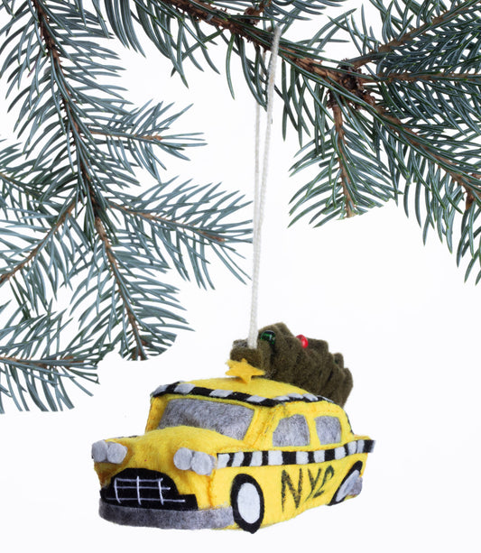 Yellow taxi-shaped ornament hanging on a Christmas tree branch