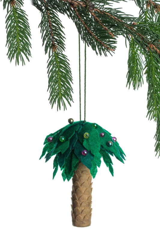 Palm tree ornament with green leaves hanging from a branch on a white background