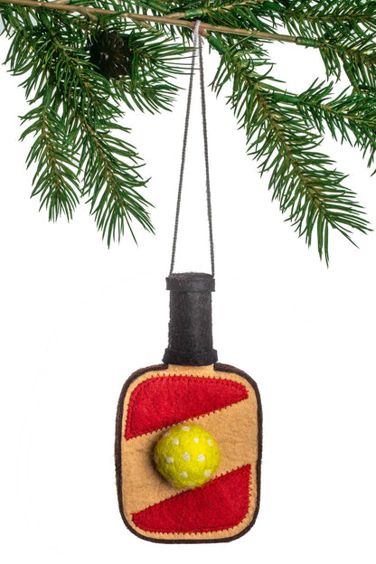 Decorative pickleball paddle ornament hanging on a Christmas tree branch.