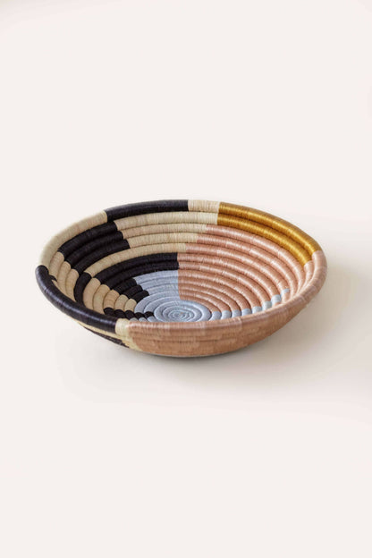 Woven bowl with multicolor pattern on a white background