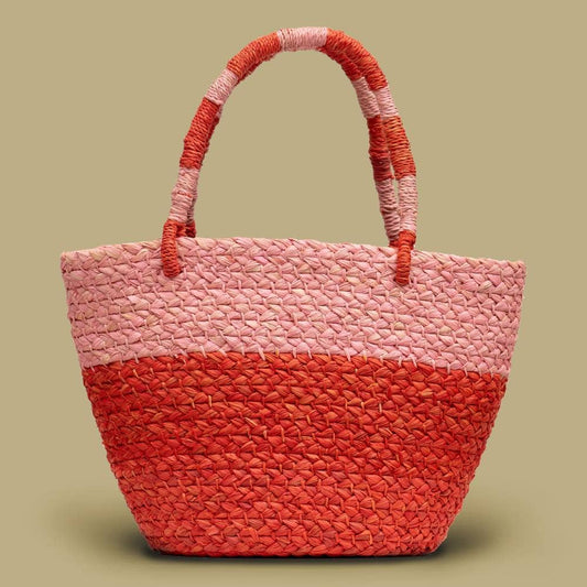 Woven tote bag with red and pink color scheme on a beige background
