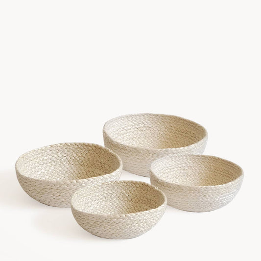 Set of four woven bowls on a white background