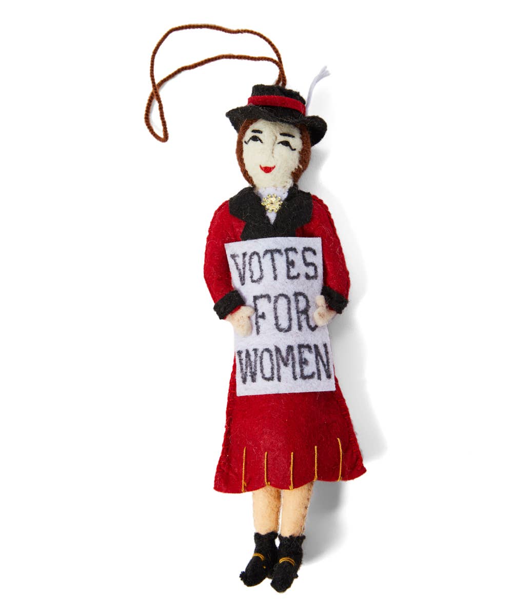 Felt doll in a red dress holding a 'Votes for Women' sign on a white background