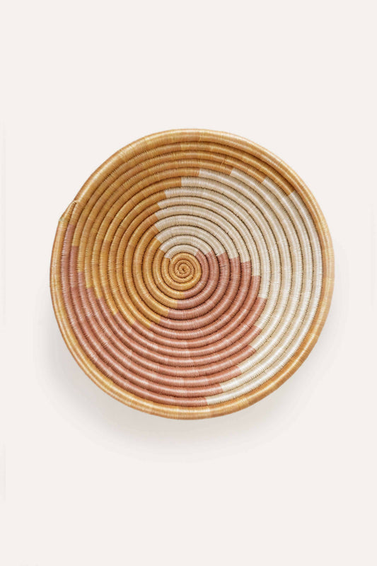 Woven basket with concentric circle pattern on a white background