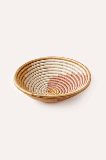 Woven bread basket with a natural wood finish on a white background