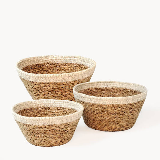 Three woven baskets of different sizes on a white background
