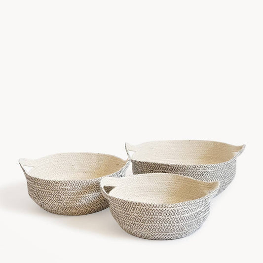 Three woven baskets of different sizes on a white background