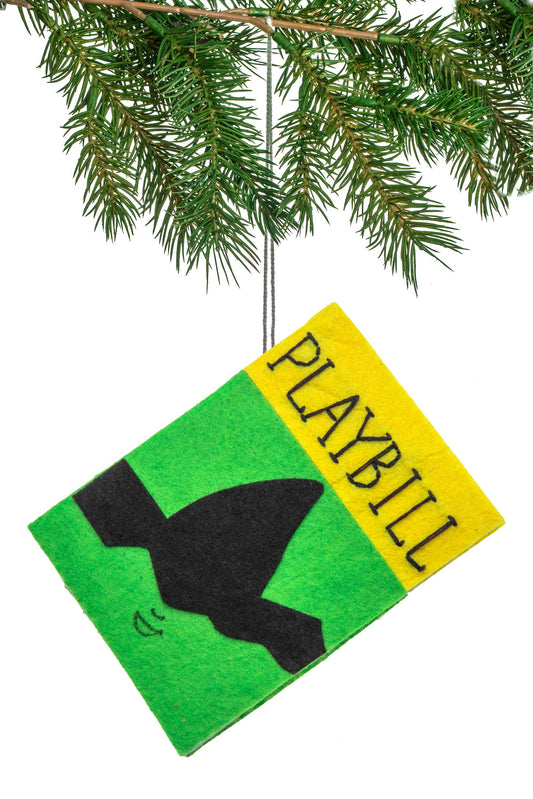 Playbill ornament with green and yellow design hanging from a branch