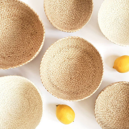 Woven baskets of various sizes on a white background with lemons.