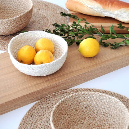 Woven bowls with lemons on a wooden surface